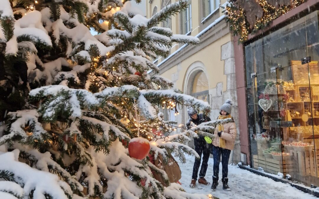 Festive Christmas scene in Kraków with holiday markets, decorated trees, and illuminated streets.