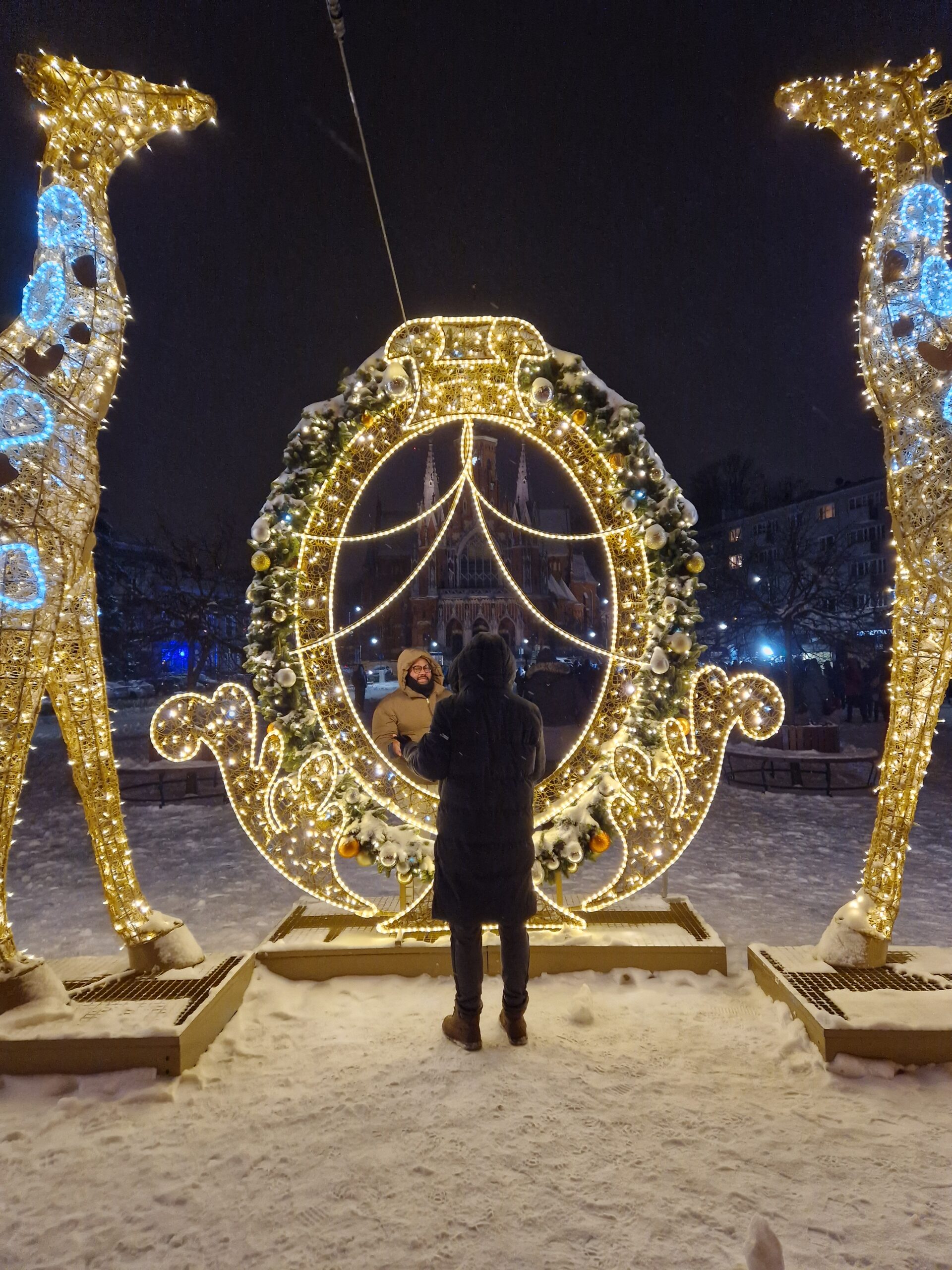 Festive Christmas scene in Kraków with holiday markets, decorated trees, and illuminated streets.